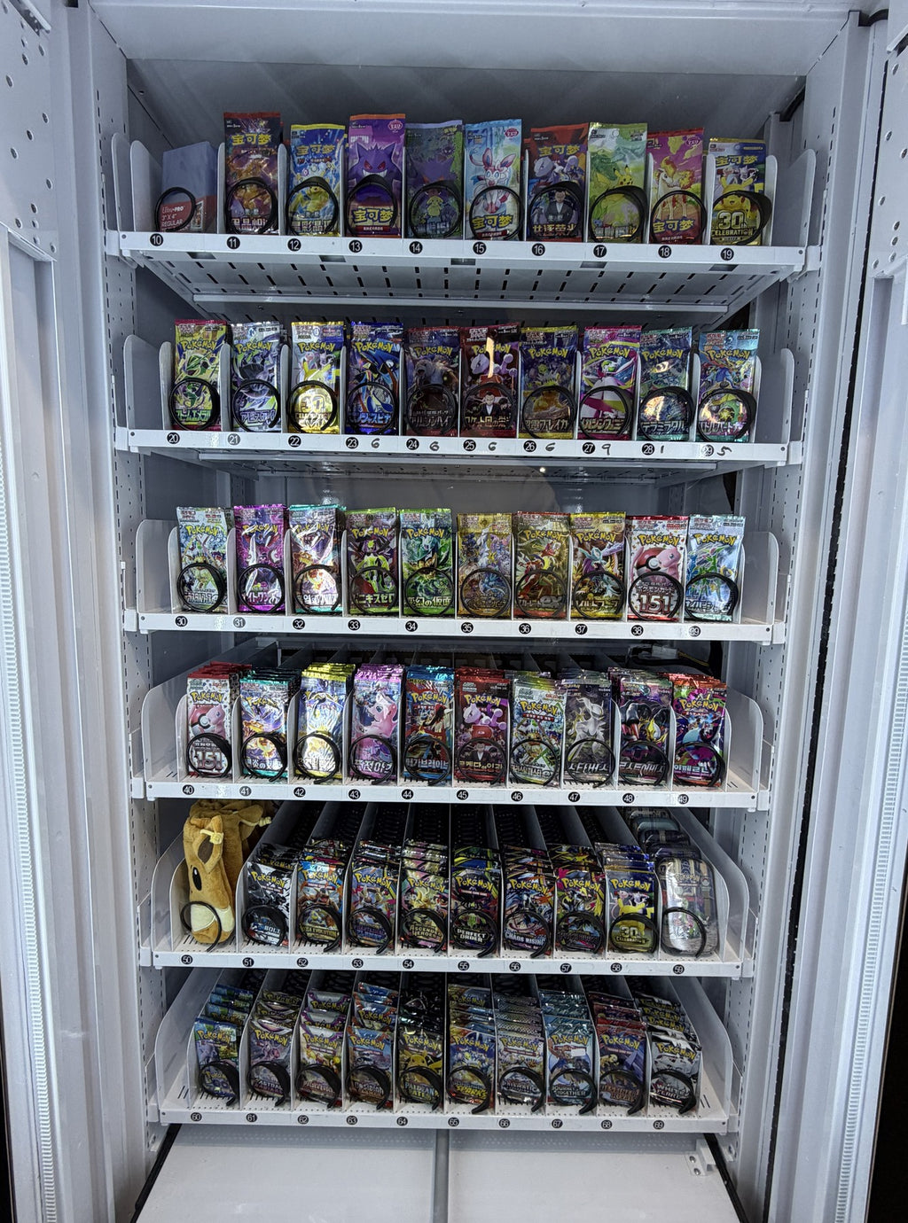 Stocked VendMax Pokémon pack vending machine — Packline inventory purchasing