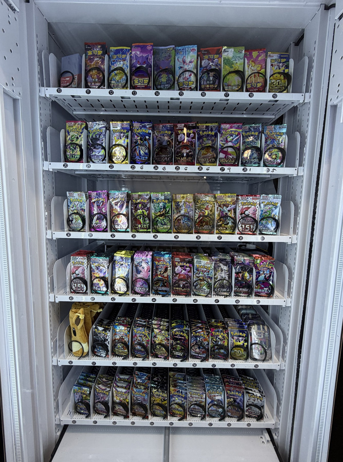 Stocked VendMax Pokémon pack vending machine — Packline inventory purchasing